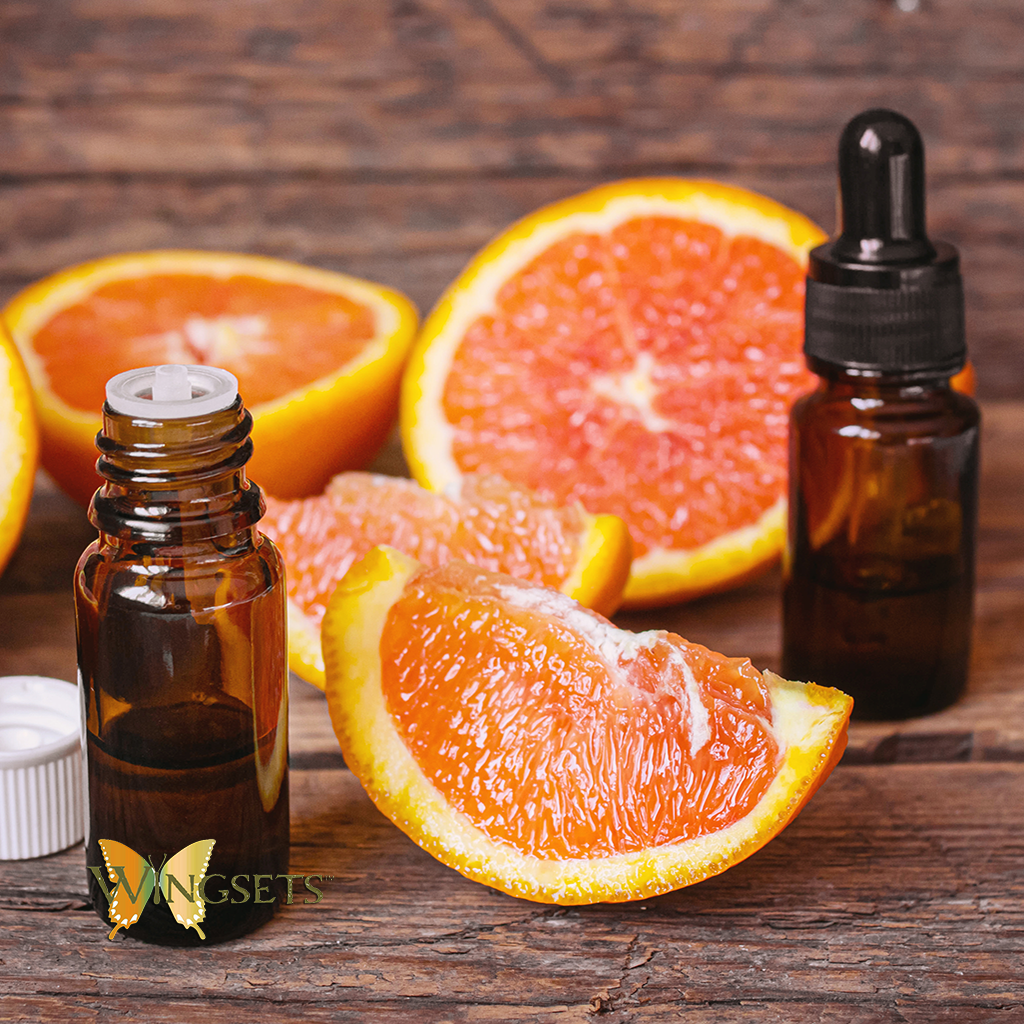 pink grapefruit essential oil, aromatherapeutic, picture of fruit, organically produced in the USA from the peel of the fruit of the pink grapefruit, fresh, clean, handpoured